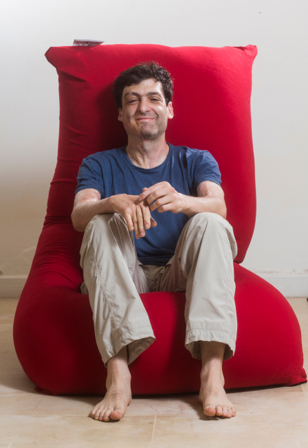 Dan Ariely sitting on a bean bag chair